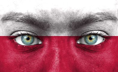 Human face painted with flag of Poland