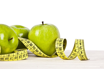 green apples with tape measure, concept of healthy diet