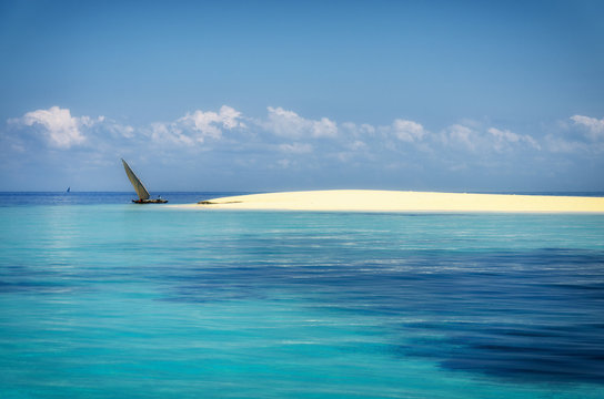 Indian Ocean sand bank with dhow (traditional Swahili boat), off the coast of Dar Es Salaam, Tanzania