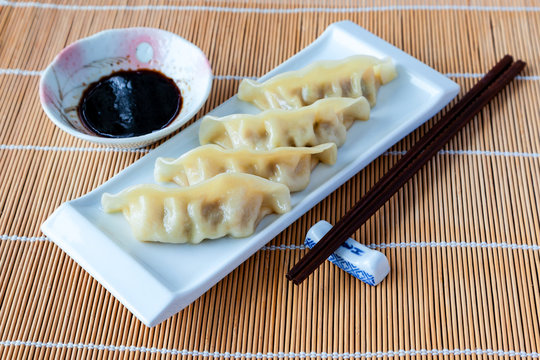 Delicious gyoza or pot stickers on bamboo mat