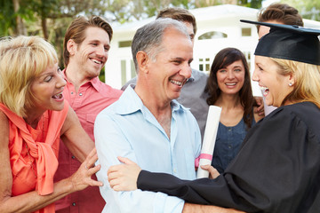 Female Student And Family Celebrating Graduation