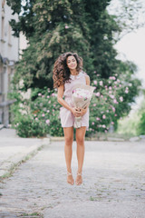 beautiful girl jumping with a bouquet of peonies