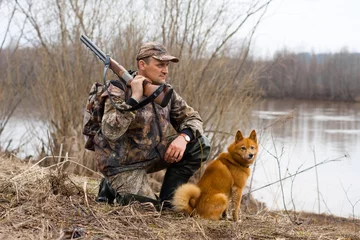 Fotobehang hunter with a dog © rodimovpavel