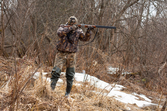 hunter takes aim from a gun