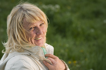 blond mature woman on green