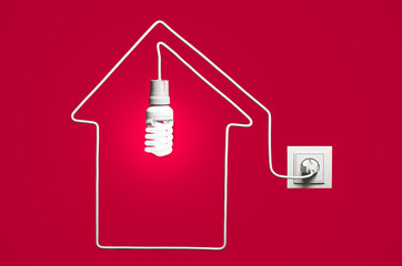 Glowing lightbulb in a house on a red background