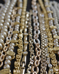 variety of golden jewelery closeup, strong bokeh