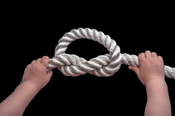 Baby hands holding overhand knot