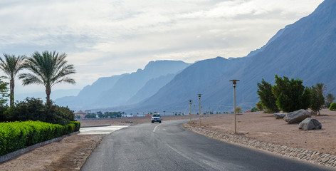 The road in the resort area of Egypt on a background of blue mou