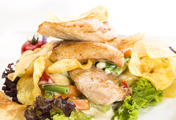 salad with chicken and potatoes on a white plate in a restaurant
