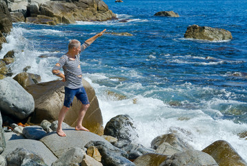 Man on stones at surf 5
