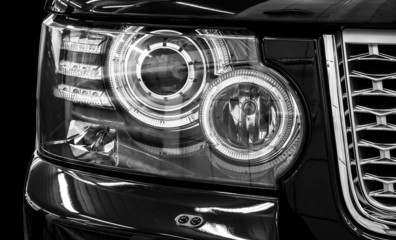 Closeup headlights of car. Car exterior detail.