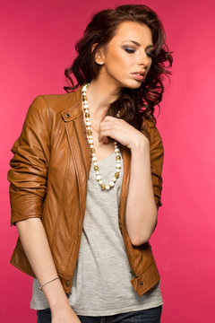 Beautiful young brunette in the leather jacket