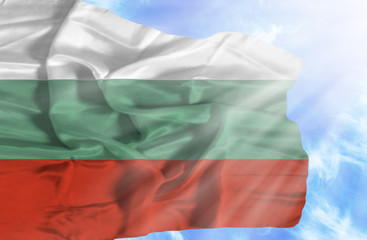 Bulgaria waving flag against blue sky with sunrays