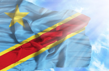 Congo Democratic Republic waving flag against blue sky with sunr