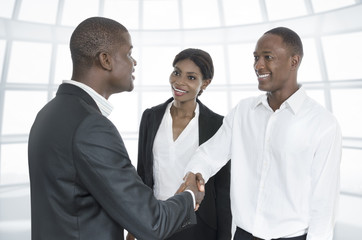 Three african business people handshake