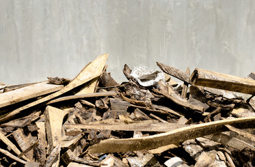 Cement wall and scraps of wood foreground