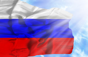 Russia waving flag against blue sky with sunrays
