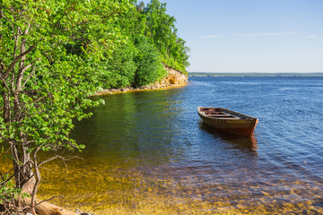 wooden boat on the river bank