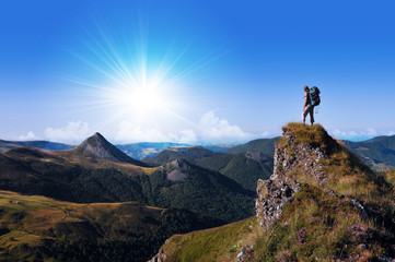 hiker on top of a rock looking far away
