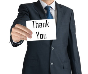 businessman holding a white sheet of paper with the inscription: thank you