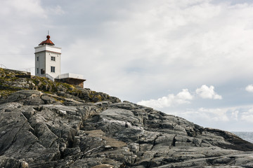 Fototapeta na wymiar Lighthouse on a rocky cliff