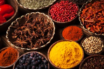 Poster Spices and herbs in wooden bowls. © BrunoWeltmann