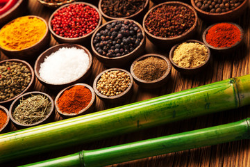 Spices and herbs in wooden bowls.