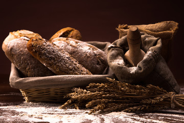 Fresh bread and wheat on the wooden table