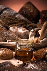 Fresh bread and wheat on the wooden table