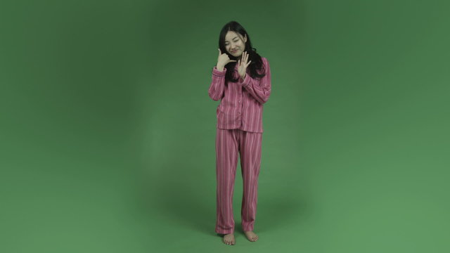 Young Asian Adult Woman In Pajamas Isolated On Green-screen