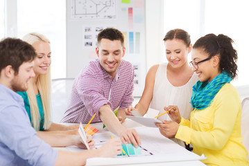smiling interior designers working in office
