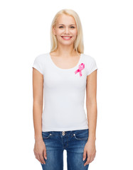 smiling woman with pink cancer awareness ribbon