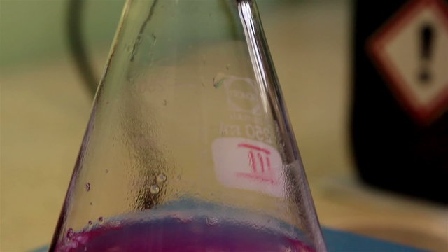 A flask with purple solution inside