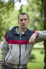 Naklejka premium Portrait of a young man out for a walk in the park