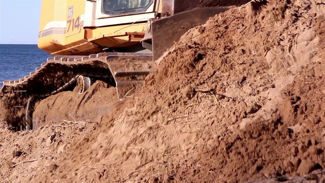 Brown soil being pushed by the bulldozer