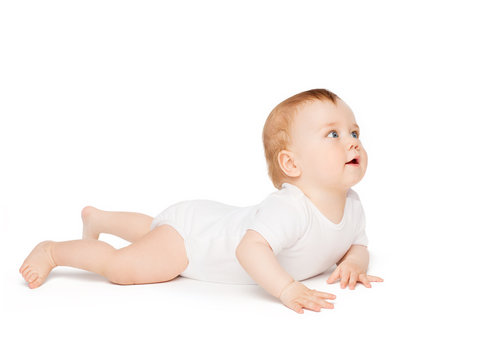 smiling baby lying on floor and looking up