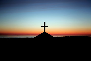 Silhouette cross on chapel