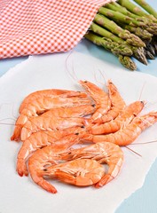 King shrimps on blue background with asparagus