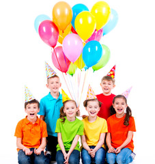 Happy boys and girls with colored balloons.