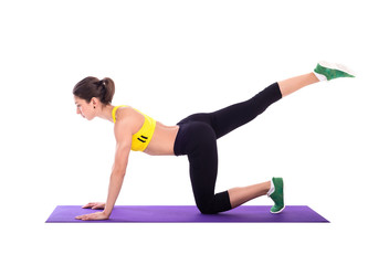 Fitness woman doing stretching exercises on foam pad