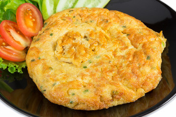 close up of omelette on the black dish