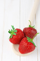 Strawberries on white wood