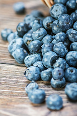 Fresh blueberries scattered on the wooden table