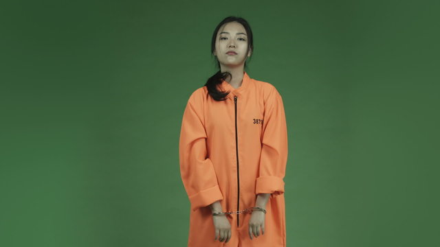 young asian adult woman prisoner isolated on green-screen