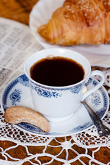 Cup of coffee, cookie and croissant.