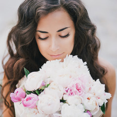 beautiful girl with a bouquet of peonies