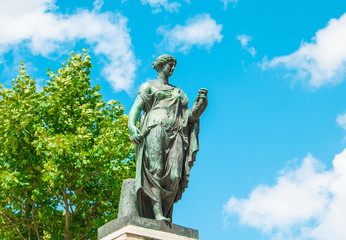 Obraz premium Park sculpture of ancient goddess with wreath in hand