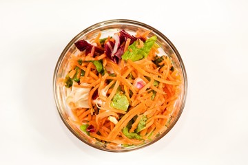 Colorful vitamin salad in glass bowl.