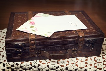 White envelope on leather case.